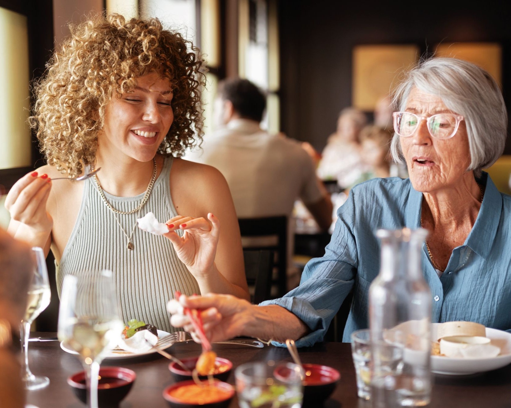 Eine jüngere und eine ältere Frau sitzen gemeinsam am Tisch und essen | © AIDA Cruises