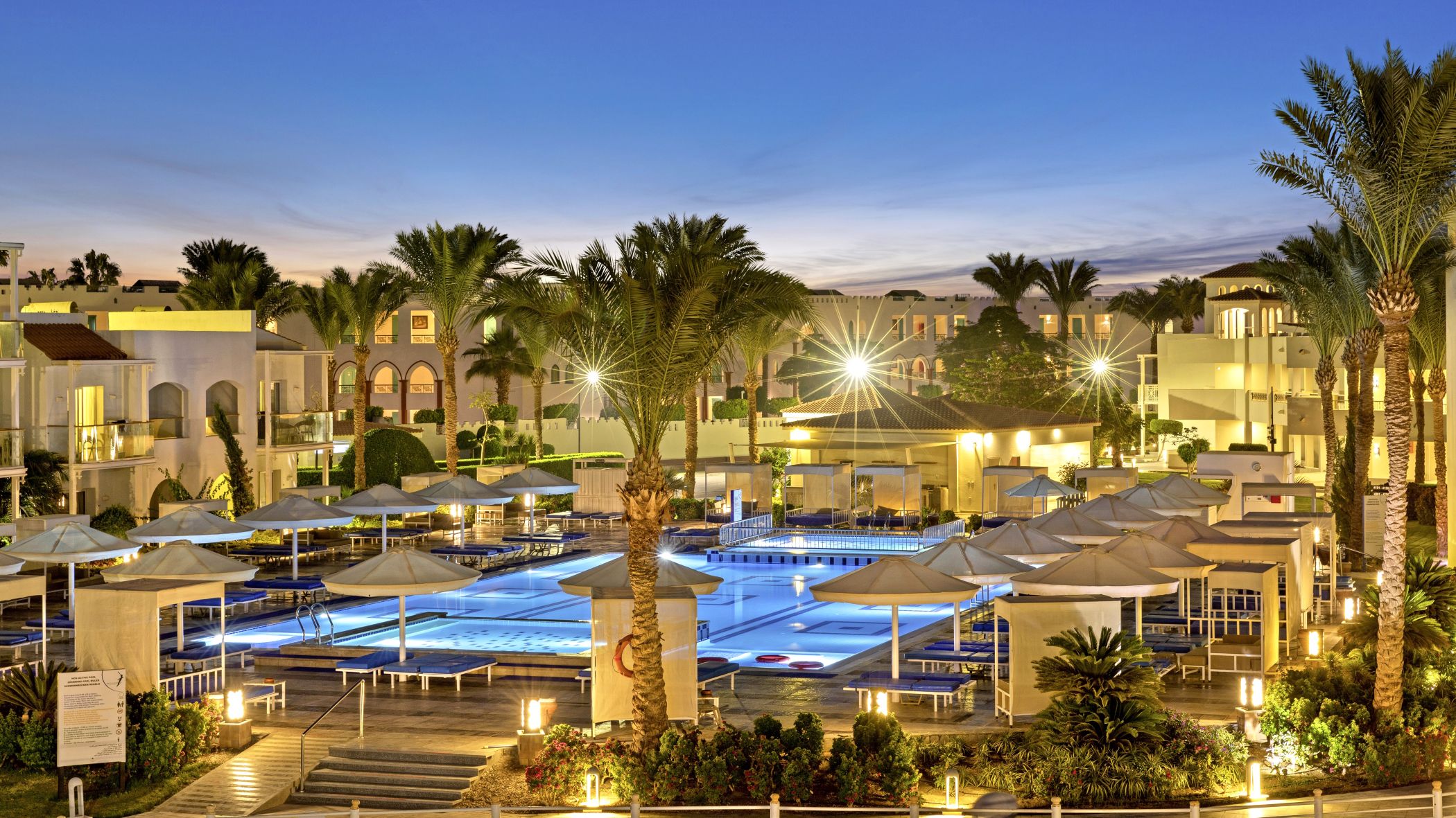 Die Anlage und der Poolbereich des Pickalbatros Dana Beach Resorts in der Dämmerung | © DERTOUR